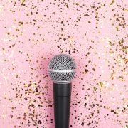 A,Microphone,On,Pink,Background,Decorated,With,Confetti.,Minimal,Compostion.